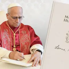Papież w czerwonej szacie pisze, a obok księga "Magnifica Humanitas". Jego sumienie kieruje pióro.