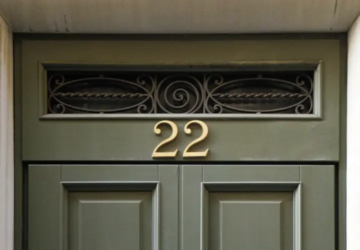 Złote liczby 22 na zielonych drzwiach. Może to znak, że czekają na Ciebie anielskie liczby i pozytywne zmiany.