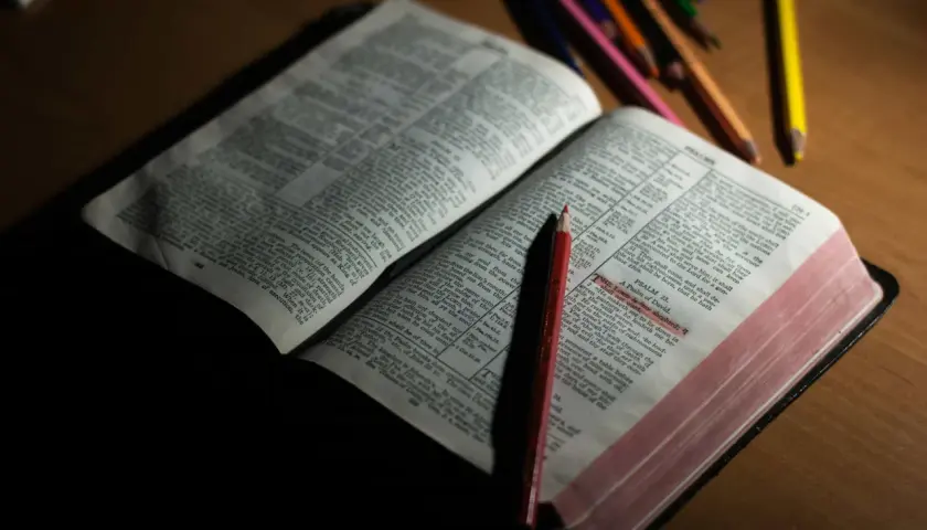 Otwarta Biblia z zaznaczonym fragmentem Psalmu 23. Obok leżą kredki, sugerujące modlitwę o mądrość.